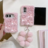 Pink fluffy iPhone case with bow embellishments and pearl accents