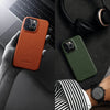 IPhone with leather case beside desk setup