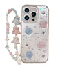 iPhone 16 with star glitter case and accessory chain.