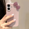 Side view of pink glitter bow iPhone 16 Pro case showing grip.